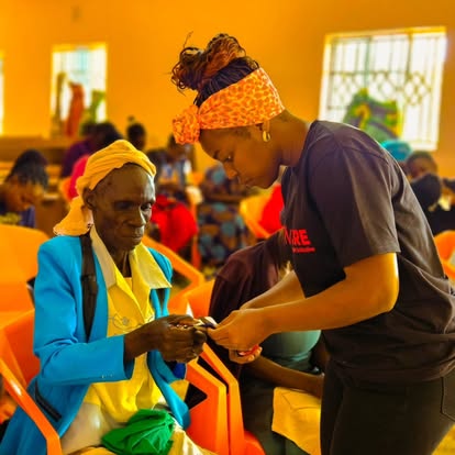 Elderly and marginalized community members being supported