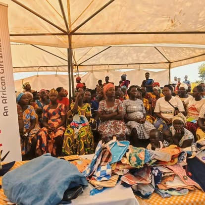 Community pad-making training session under a tent