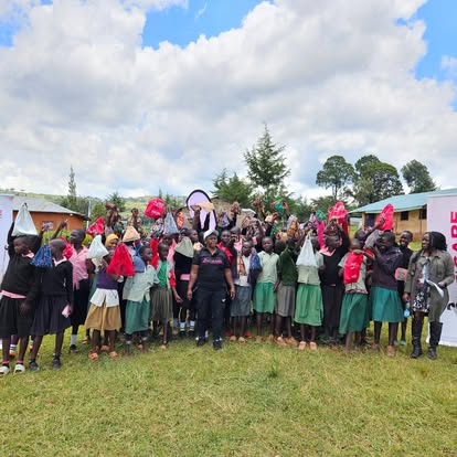 Girls celebrating with their new pad kits after distribution