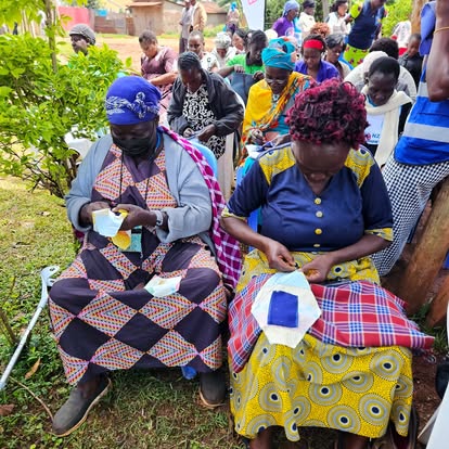 Women learning to stitch reusable pads together