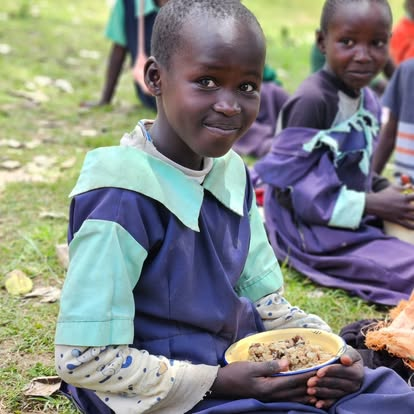 A girl enjoying her school meal