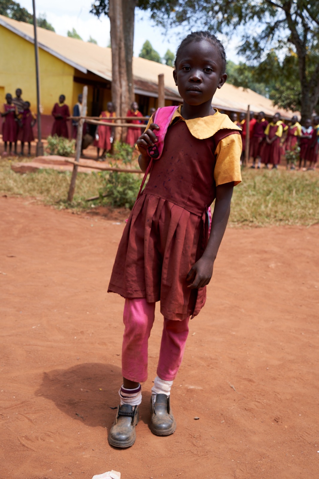Before: a learner in a worn dress and old boots