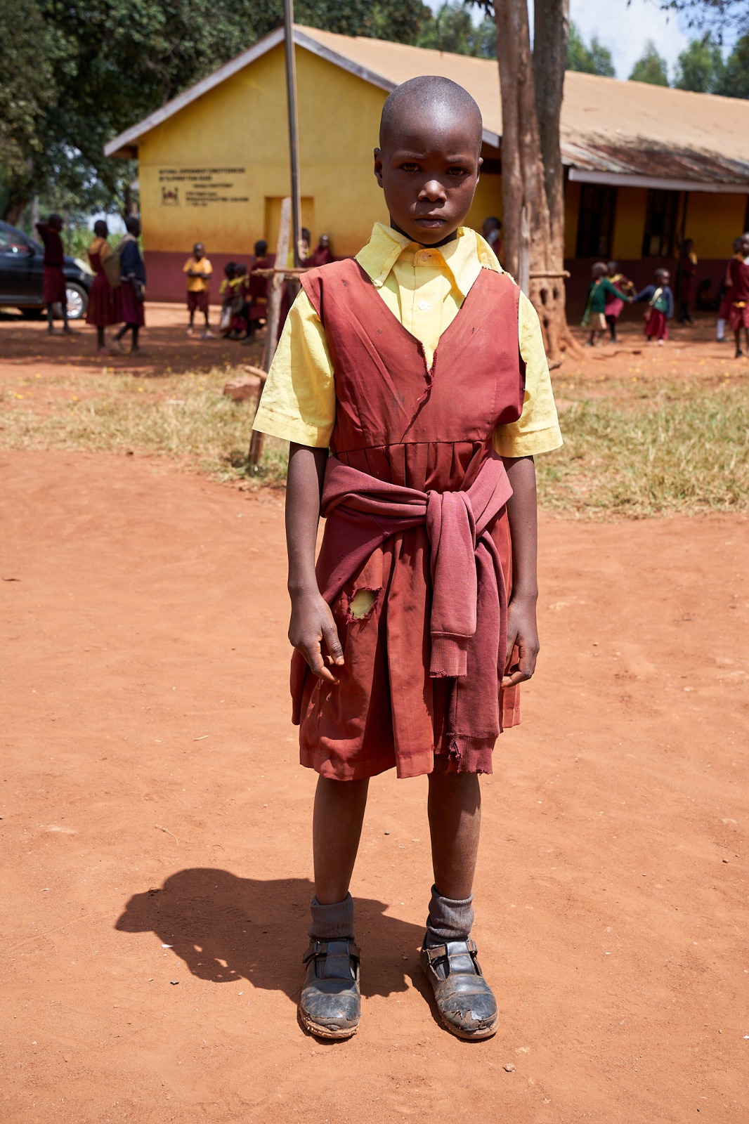 Before: a learner in a torn, tied vest